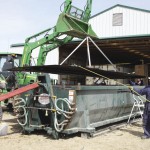 Farmers working on a farm implement