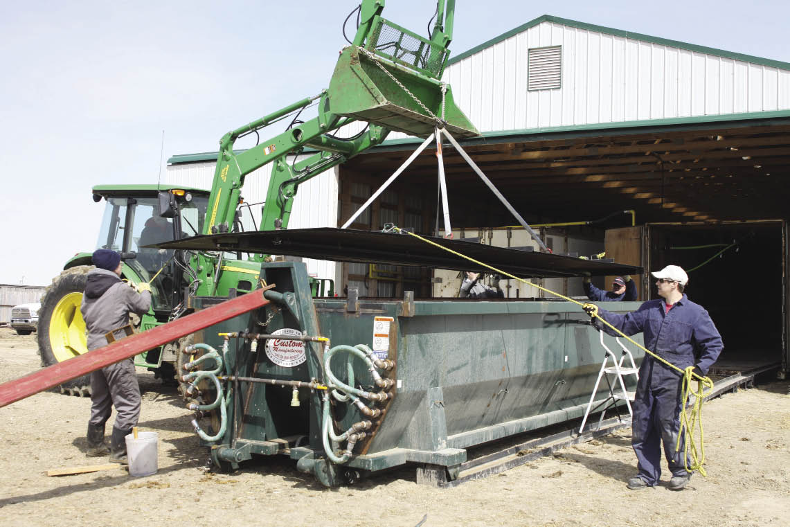 Farmers working on a farm implement