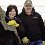 Man and woman leaning on a tree.