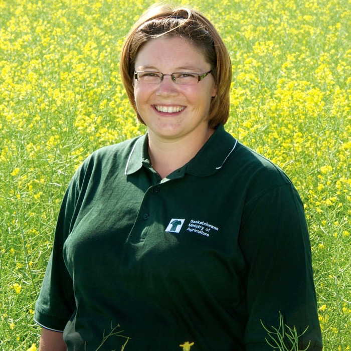 woman standing in a canola field
