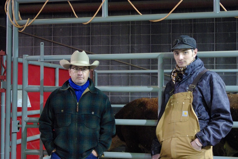Ross Macdonald and Daniel Doerksen stop visiting long enough for a photo in the commercial cattle area.