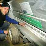 Inventor Gerard Roney points to the bars that control how much grain animals can lick up each visit.