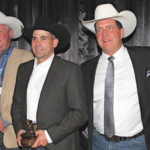 LMAC’s industry champion Danny Skeels (centre) accepts the limited-edition bronze auctioneer figurine from peers (l. to r.) Dean Edge, Blair Vold, Rob Bergevin and Chance Martin.