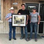 Brian Good (l) of the Canadian Angus Association presents the award to Jordan and Megan Kolk.