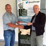 Greg Penner of the University of Saskatchewan, congratulates Dr. David Christensen (right) on winning the 2017 SFC Forage Industry Innovation Award.