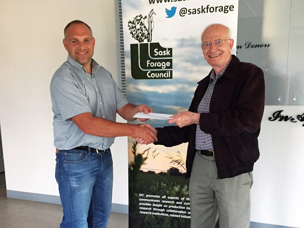 Greg Penner of the University of Saskatchewan, congratulates Dr. David Christensen (right) on winning the 2017 SFC Forage Industry Innovation Award.