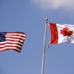 American and Canadian flag flying side by side.