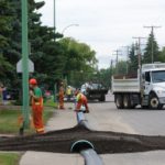 Workers in Prince Albert, Sask. lay out a temporary line in late July to supply drinking water to city residents after shutting the municipal water intake from the North Saskatchewan River. (CityPA.ca)
