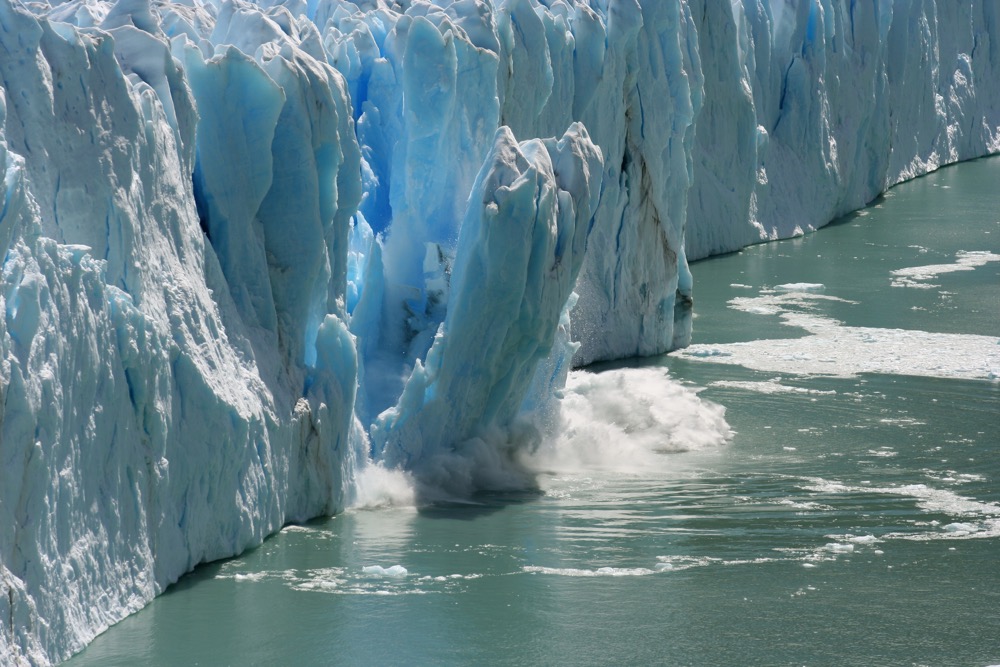 A portion of a melting glacier calves off into the ocean.  Photo: Thinkstock
