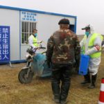 Workers in protective suits disinfect a vehicle at a checkpoint on a road leading to a farm owned by Hebei Dawu Group where African swine fever was detected, in Xushui district of Baoding, Hebei province, China on Feb. 26, 2019. (Photo: Reuters/Hallie Gu)