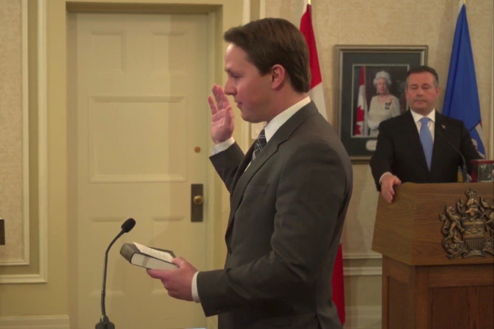 Devin Dreeshen is sworn in on April 30, 2019 as Alberta’s agriculture minister; Premier Jason Kenney looks on. (Video screengrab from Government of Alberta via YouTube)
