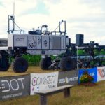 The U-shaped Dot A-U1 “loads” a SeedMaster row-crop planter on to its platform during the demonstration at Canada’s Outdoor Farm Show. (Ralph Pearce photo)