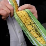 A guest looks at their corn cob-themed tie signed by U.S. President Donald Trump during a signing ceremony for the Canada-U.S.-Mexico Agreement (CUSMA) on the South Lawn of the White House in Washington on Jan. 29, 2020. (Photo: Reuters/Leah Millis)