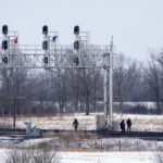 Four men walk along rail tracks near a blockade at Tyendinaga, Ont., east of Belleville, on Feb. 22, 2020. (Photo: Reuters/Carlos Osorio)