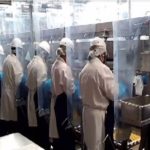 Workers in Cargill's High River plant on the line in the spring of 2020. The photo, taken from a company presentation, shows the plastic barriers the company has installed to prevent the spread of COVID-19.
