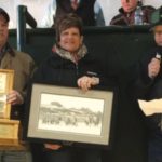 Cam and Myrna Schweitzer, from left, accepted the award from Blair McRae, Canadian Simmental Association representative.