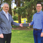 Dr. John Basarab accepted the Don Matthews Memorial Award on behalf of Livestock Gentec from Michael Latimer of CBBC.