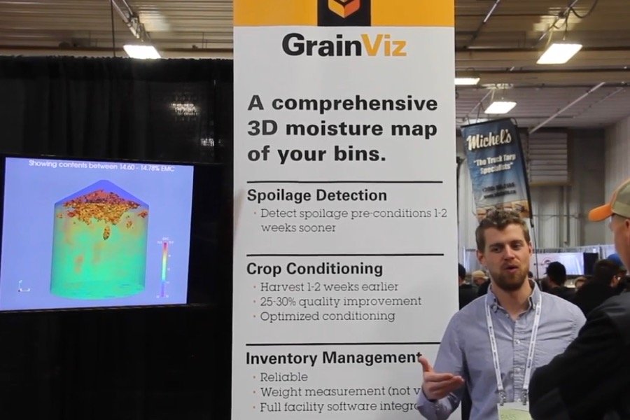 GrainViz engineer Braden Pierce explains the system to farmers at Ag Days at Brandon, Man. in 2018. (Screengrab from GFM/Greg Berg video)
