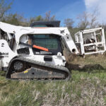 Todd Hermanson’s Wire Shark mounts on a skid steer to ease the job of pulling and rolling wire.