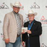 Presenting 2019 Canadian Livestock Auctioneering Champion Ryan Konynenbelt with the CAA-sponsored champion buckle.
