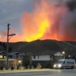 Smoke rises from a wildfire over a hill at Kamloops, B.C. on July 1, 2021, in this screen grab obtained from a social media video. (Nicole Ritter via Reuters)