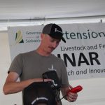 Katlin Lang, CEO of FarmSimple, shows attendees at the livestock tent at Ag in Motion his Herd Hand device.