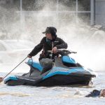 Cows that were stranded in a flooded barn at Abbotsford, B.C. are rescued on Nov. 16, 2021 by people in boats and on a jet-ski after rainstorms lashed the province, triggering landslides and floods and shutting highways. (File photo: Jennifer Gauthier/Reuters)