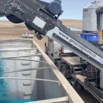 A G-Mac’s custom seed treatment unit loads a truck with treated peas in a 2020 video screengrab. (G-Mac’s AgTeam via YouTube)