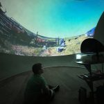 A child watches a video about branding in the SCA video dome.