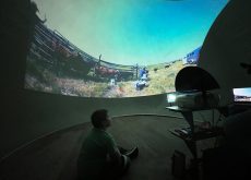 A child watches a video about branding in the SCA video dome.