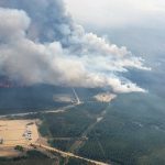 Smoke rises from the southeast side of a wildfire being tackled by helicopters near Shining Bank, Alta., about 200 km west of Edmonton, on May 19, 2023. (Photo: Alberta Wildfire/Handout via Reuters)