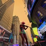 A climate change activist plays a violin in New York City’s Times Square as Manhattan is shrouded in haze and smoke which drifted south from wildfires in Canada, on June 7, 2023. (Photo: Reuters/Maye-E Wong)