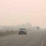 Vehicles leave Yellowknife on Aug. 16, 2023 on the only highway in or out of the city after a state of emergency was declared due to the proximity of wildfire. (Photo: Reuters/Pat Kane)