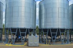 A DryAir central heating system feeds aeration fans for a row of grain bins. (Assie.ca)
