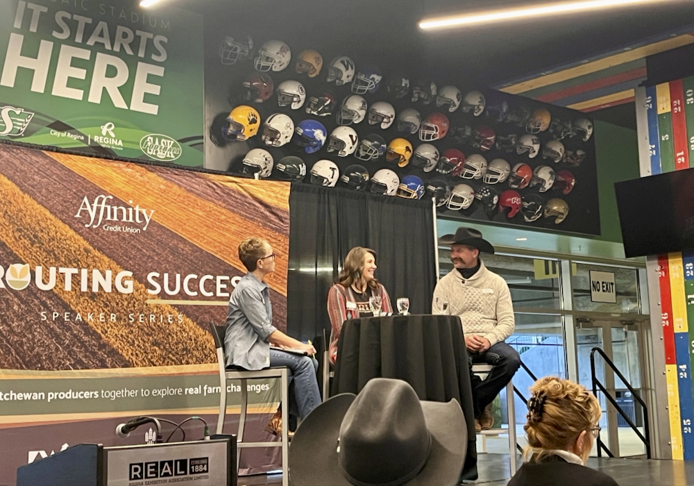Deanne Chuiko (middle) and John Chuiko (right) speak about their virtual fencing pilot at an event hosted by Ag-West Bio in Regina, Sask.