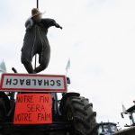 An effigy and a placard reading “Our end will be your hunger” are attached to a tractor as farm vehicles are lined up during a blockade by farmers on the A4 highway to protest over price pressures, taxes and green regulation, grievances that are shared by farmers across Europe, in Jossigny, near Paris, France, January 31, 2024. REUTERS/Stephanie Lecocq