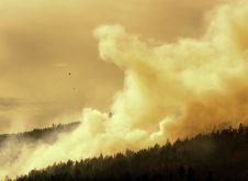 A helicopter dumps water on a forest fire in the Okanagan Valley, British Columbia.