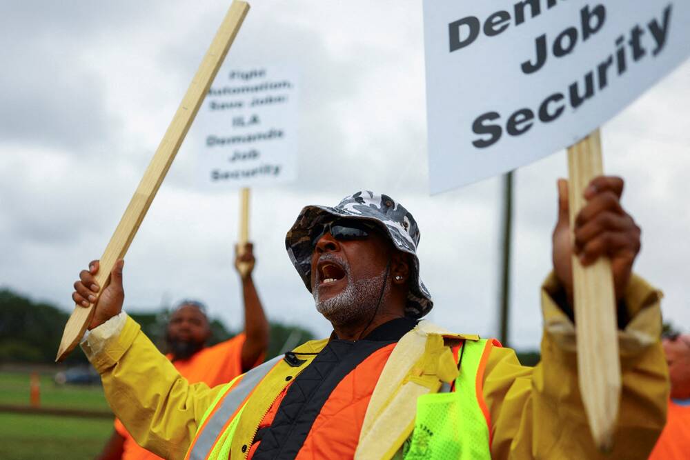 Port workers from the International Longshoremen’s Association (ILA) participate in a strike outside the Norfolk International Terminal (NIT) in Norfolk, Virginia, U.S., October 1, 2024. REUTERS/Jose Luis Gonzalez
