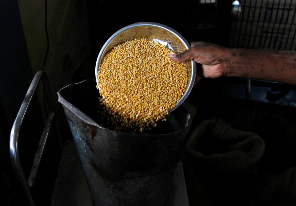 FILE PHOTO: A man weighs lentils inside his shop in the southern Indian city of Chennai July 9, 2013. REUTERS/Babu/File Photo
