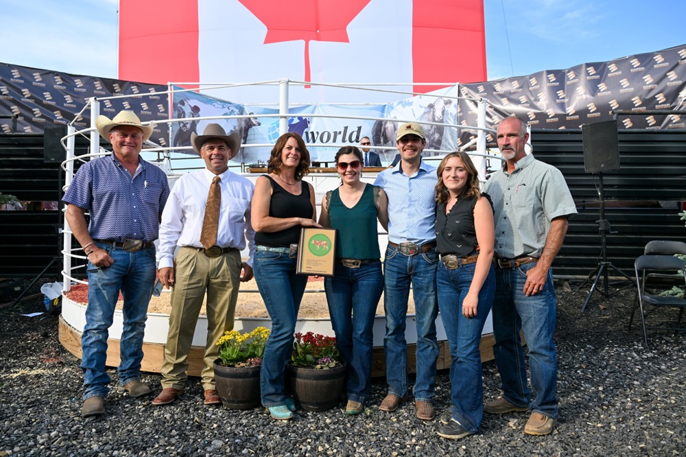 The Dimler family receives the WSFF Golden Book award at the World Simmental Federation Congress. Photo: Canadian Simmental Association
