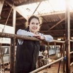 young woman in a cow barn