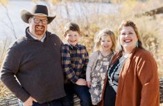 farm family with a man, woman and two young children