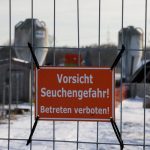 FILE PHOTO: A sign with the inscription “Beware of epidemic danger! No trespassing!” hangs on a fence in front of a farm in Mehrow, close to Ahrensfelde, Germany, January 13, 2025. REUTERS/Axel Schmidt/File Photo