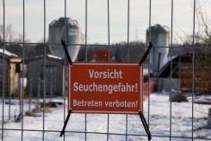 FILE PHOTO: A sign with the inscription  “Beware of epidemic danger! No trespassing!” hangs on a fence in front of a farm in Mehrow, close to Ahrensfelde, Germany, January 13, 2025.    REUTERS/Axel Schmidt/File Photo