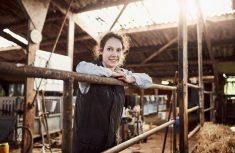 Shot of a confident young woman working at a dairy farm