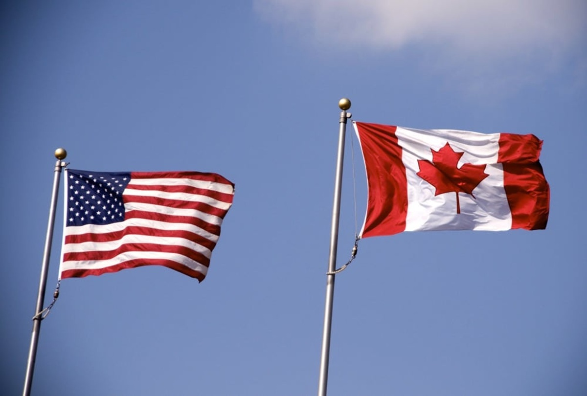 American and Canadian flag flying side by side.