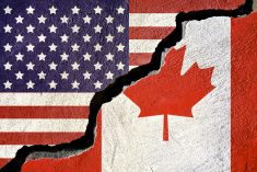 Concept american and Canada flag on cracked background