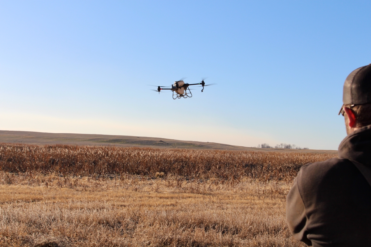 a drone flying over a farm field