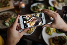 A restaurant-goer snaps a photo of a dish featuring beef. Certified sustainable beef is gaining traction in the market place, but a supply crunch makes it tough for restaurants and retailers to meet demand.