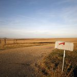 A mailbox on a rural gravel road.